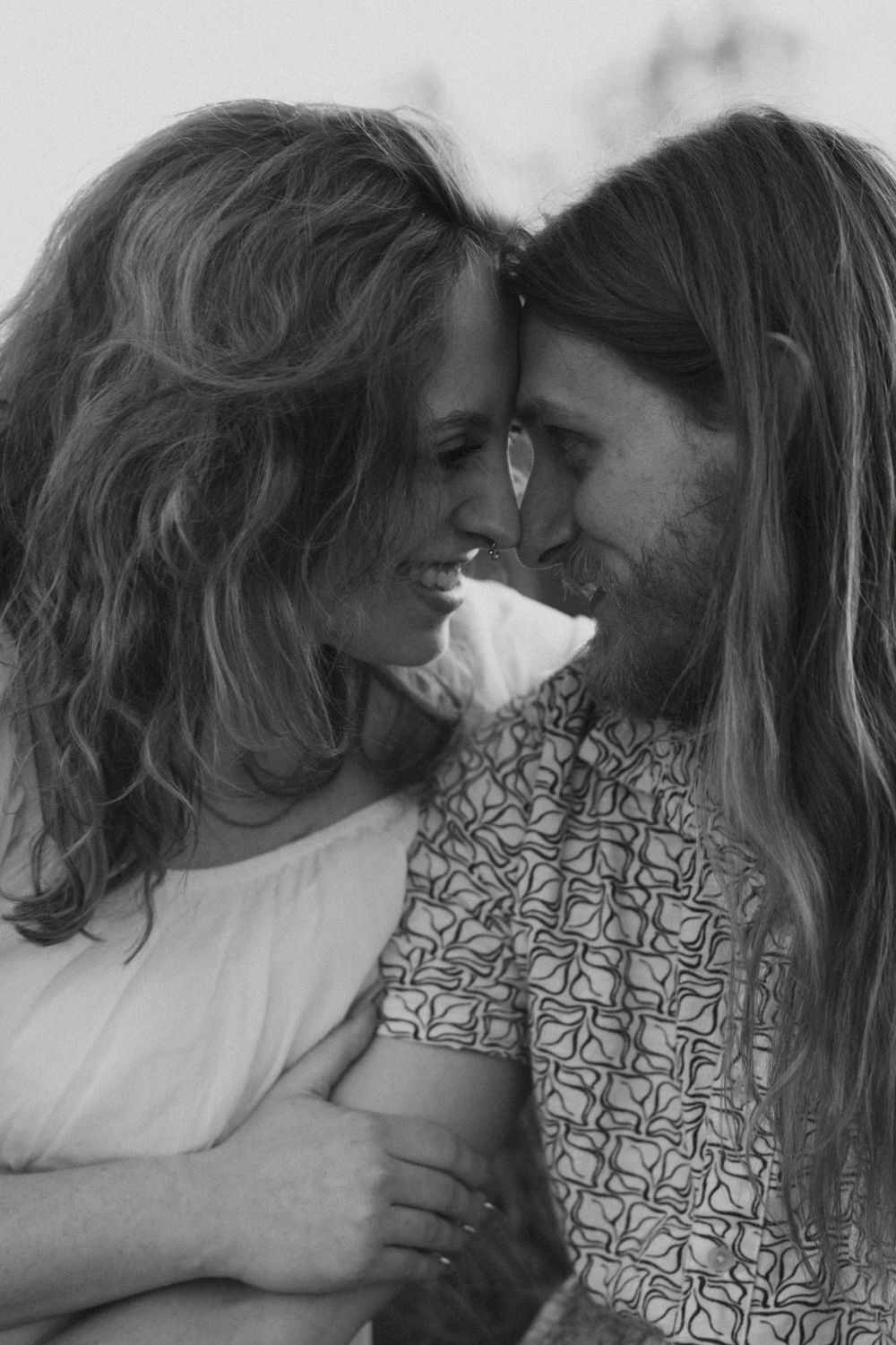 Black and white close-up portrait of a couple sharing an intimate moment together.