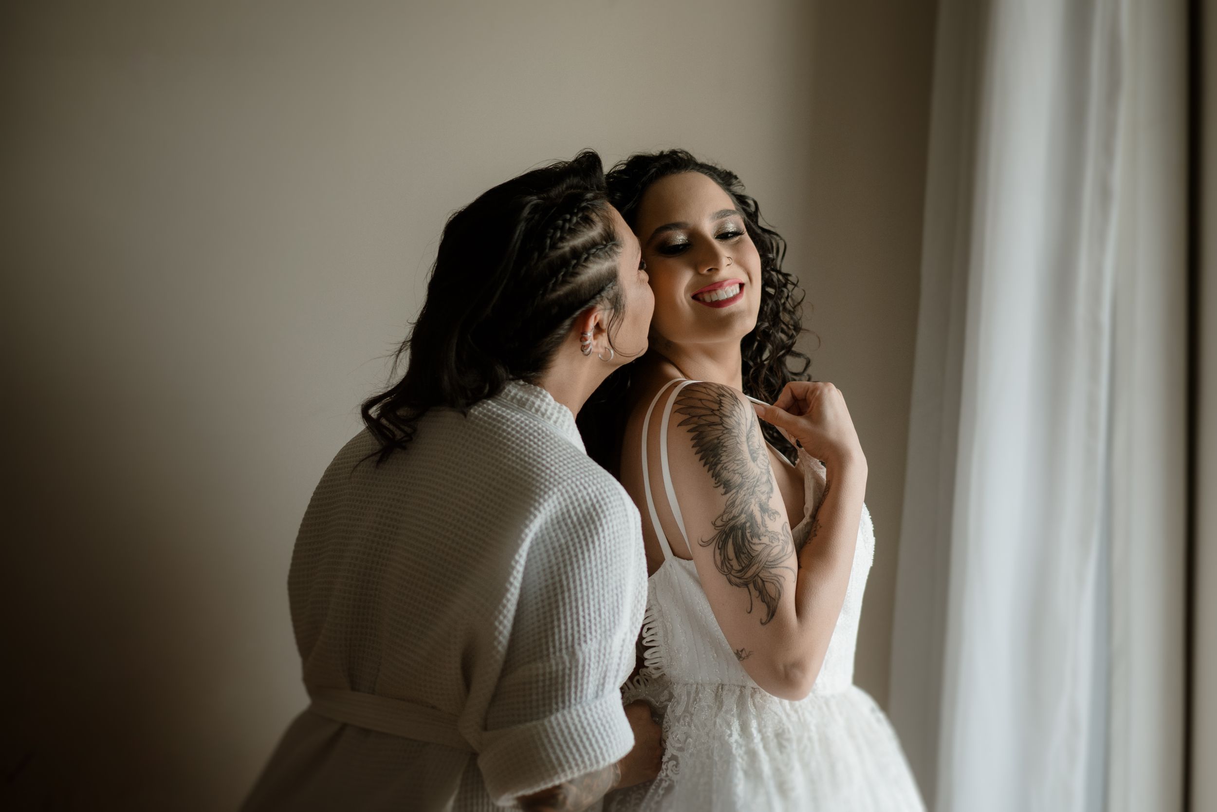 Intimate candid moment by window with natural light.