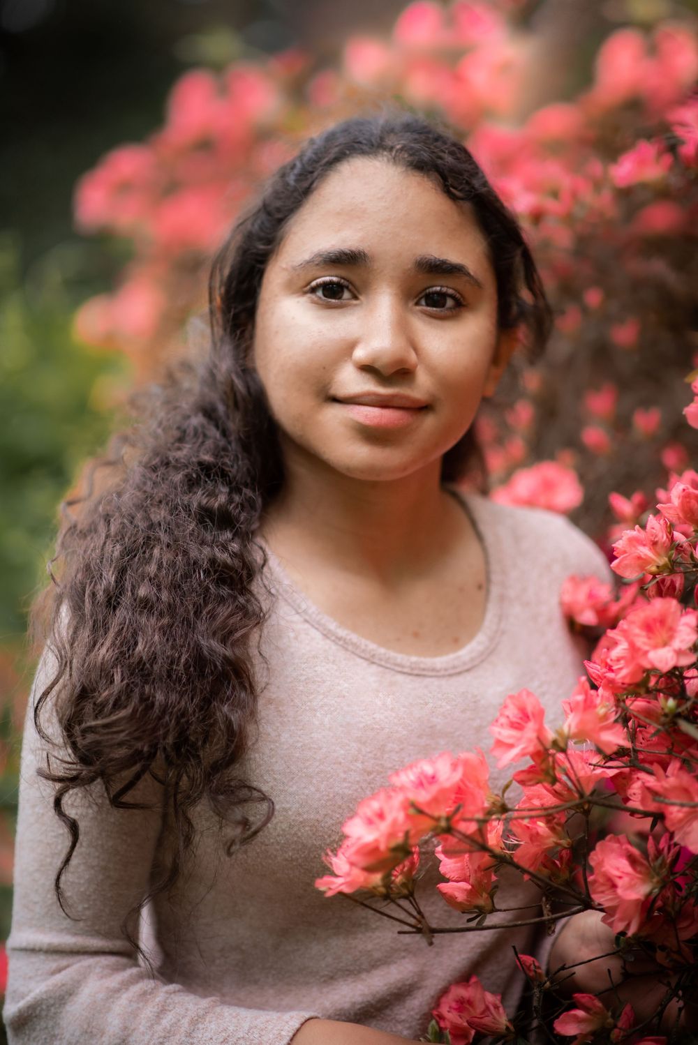 A close-up portrait with vibrant pink flowers and natural lighting.Holmdel NJ