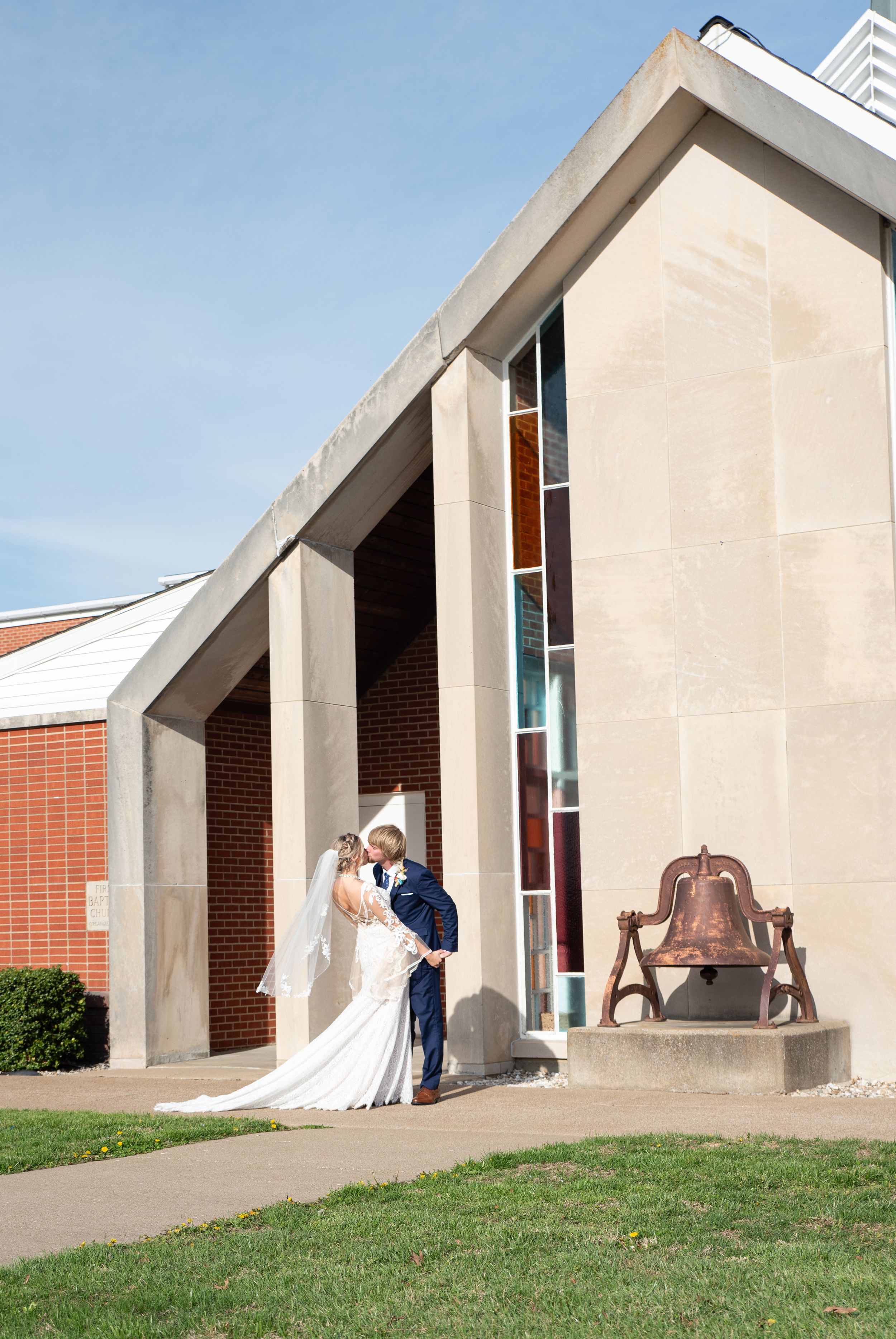 Bride and Groom sharing a kiss in front of the church in Eddyville, Kentucky