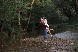 A portrait of a couple playing in a creek in western Kentucky