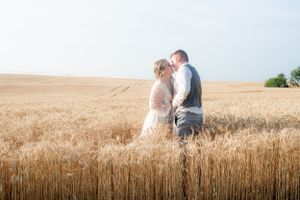 A bride and groom sharing a kiss in a wheat field in Princeton, Kentucky