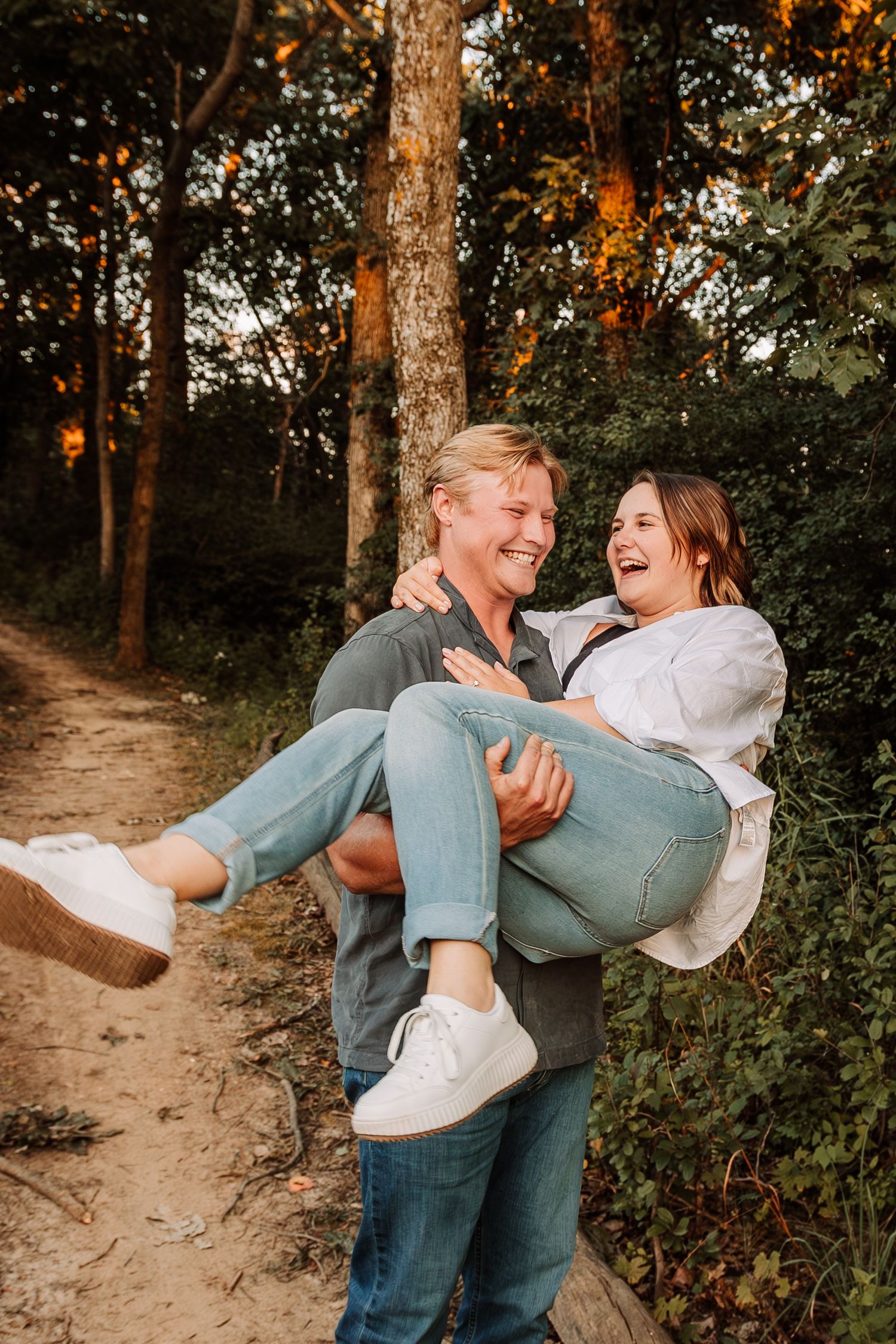 Couple laughs while the man holds his fiance as they explore Grandad Bluff