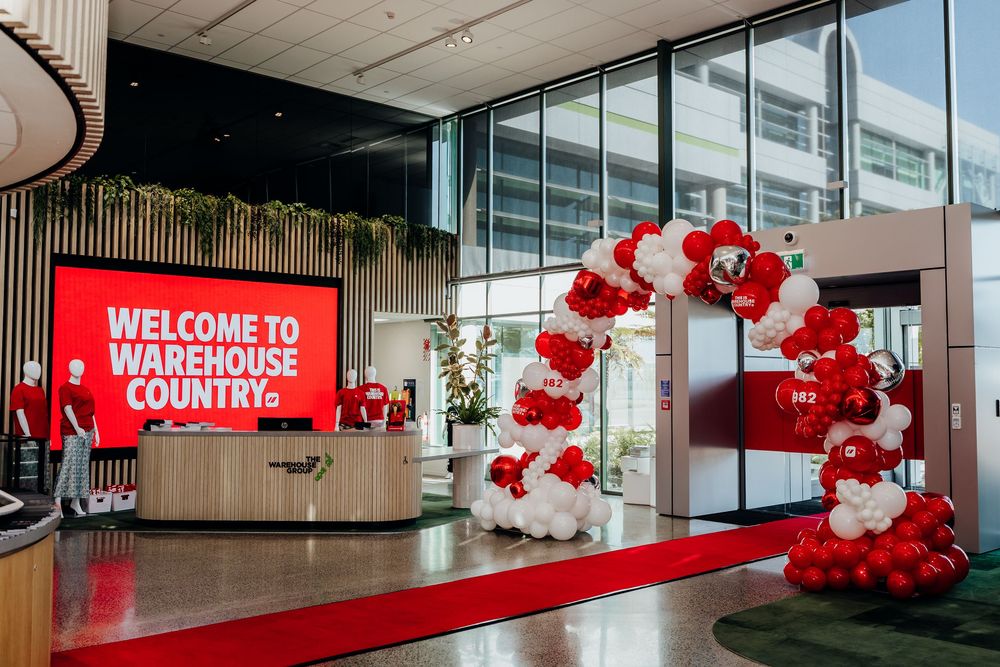 Welcome to Warehouse Country entrance with red and white balloon arch and large LED welcome sign.