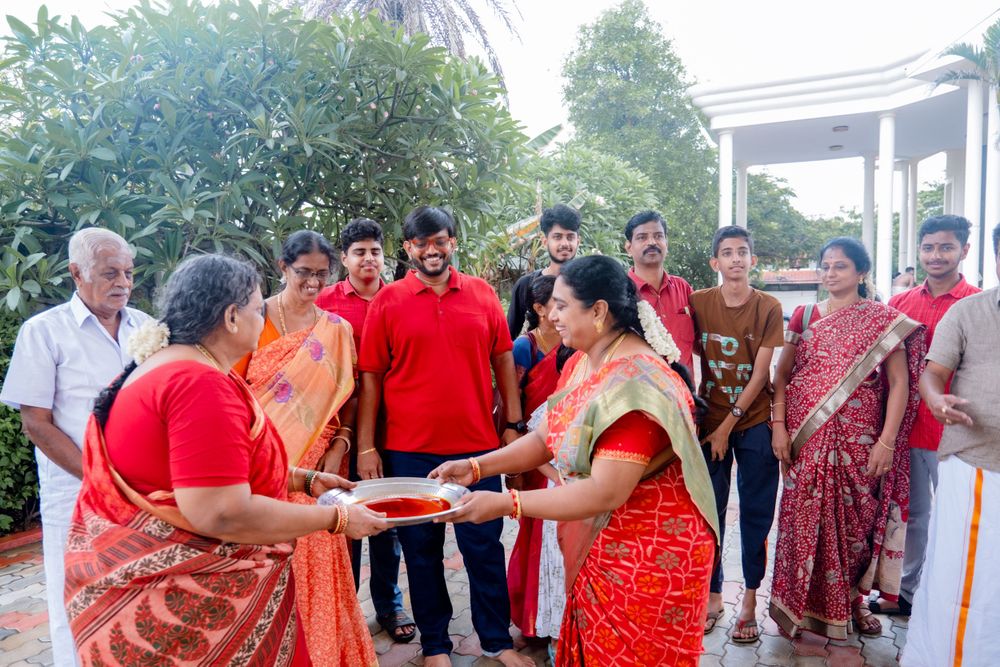 A group of people in traditional Indian attire greet each other during a cultural gathering outdoors.