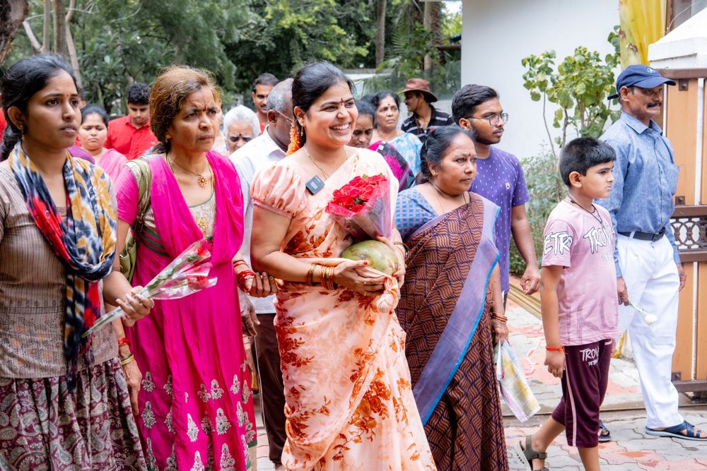 A group of women in colorful traditional Indian attire gathered at an outdoor event.