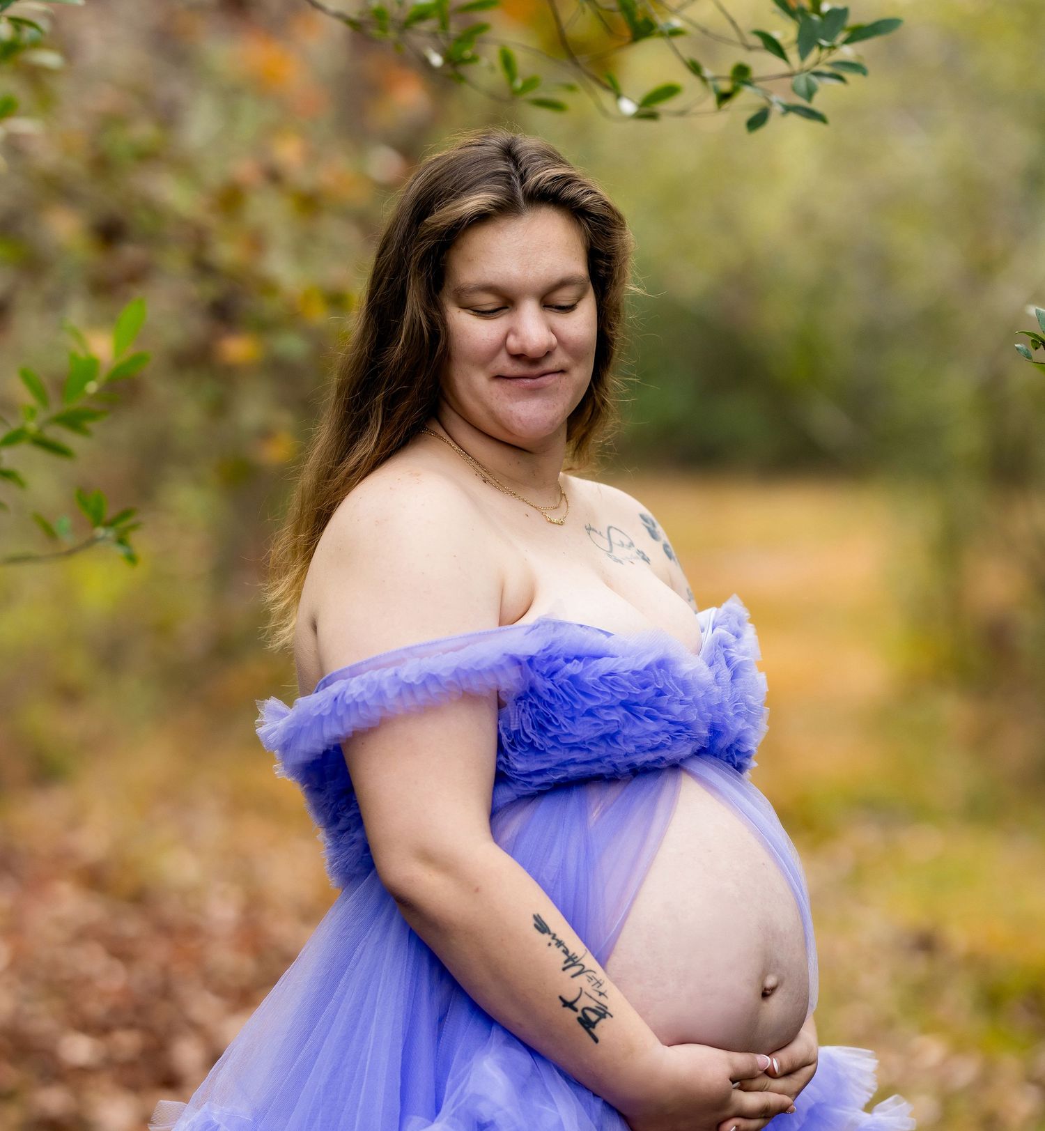 Dramatic dusty rose tulle maternity gown with ruffled details against studio backdrop.