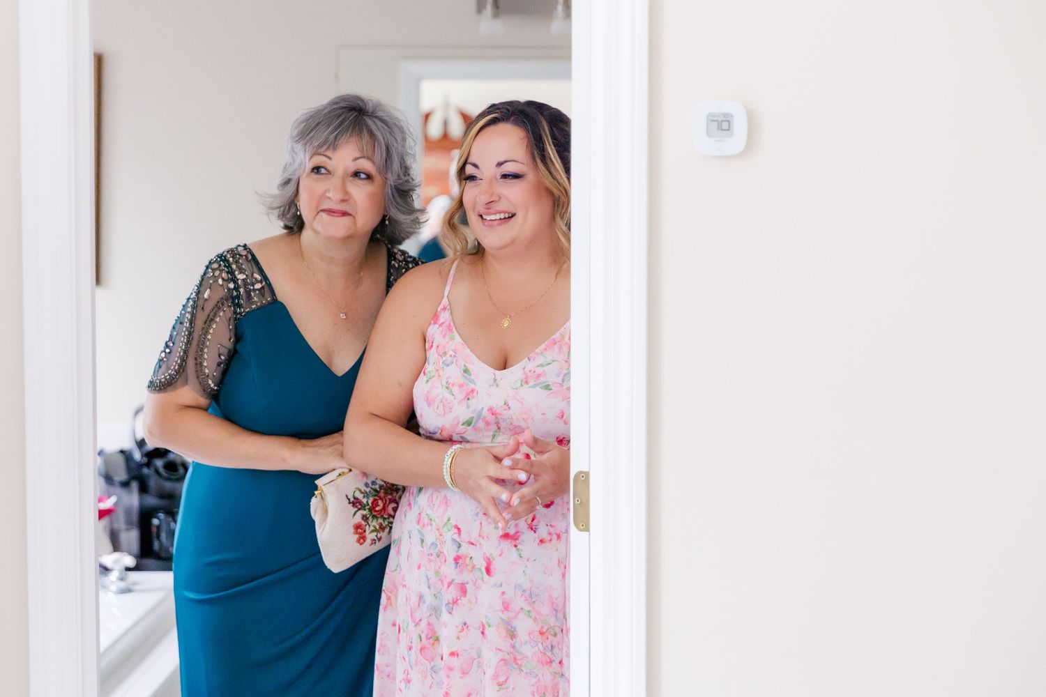 Tender moment shared during wedding day preparations in bright room.