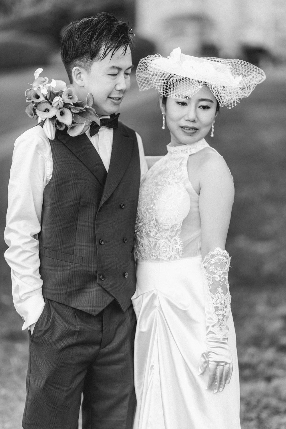 Black and white portrait of wedding couple in vintage-inspired attire.