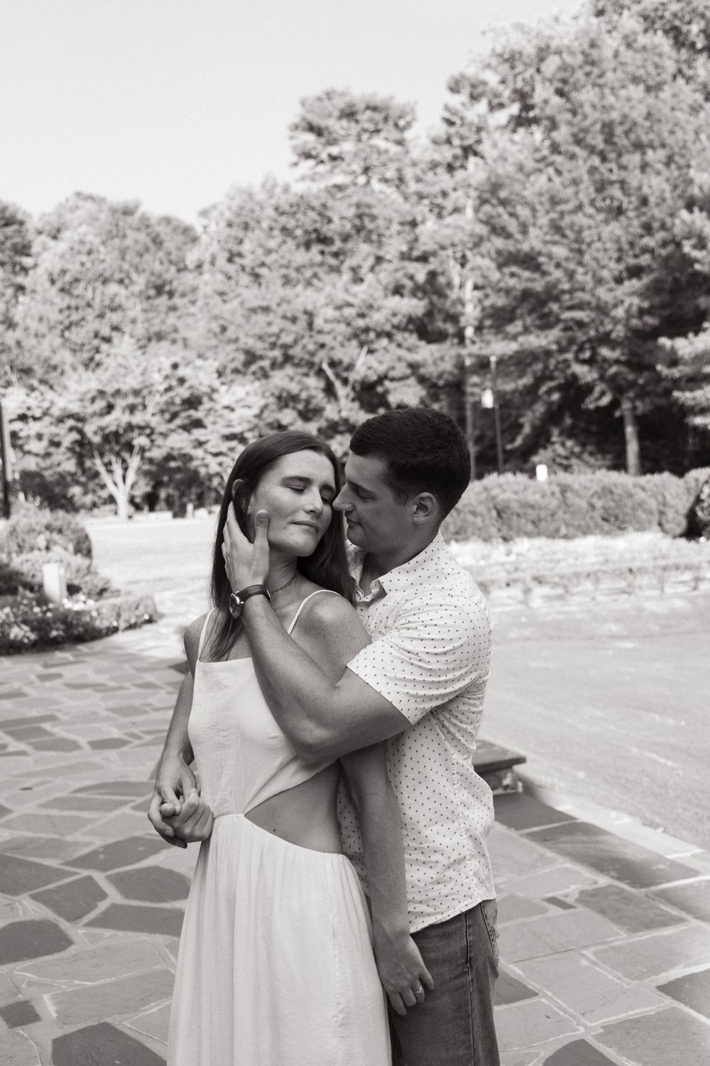 A tender moment captured in black and white on an ornate stone patio.