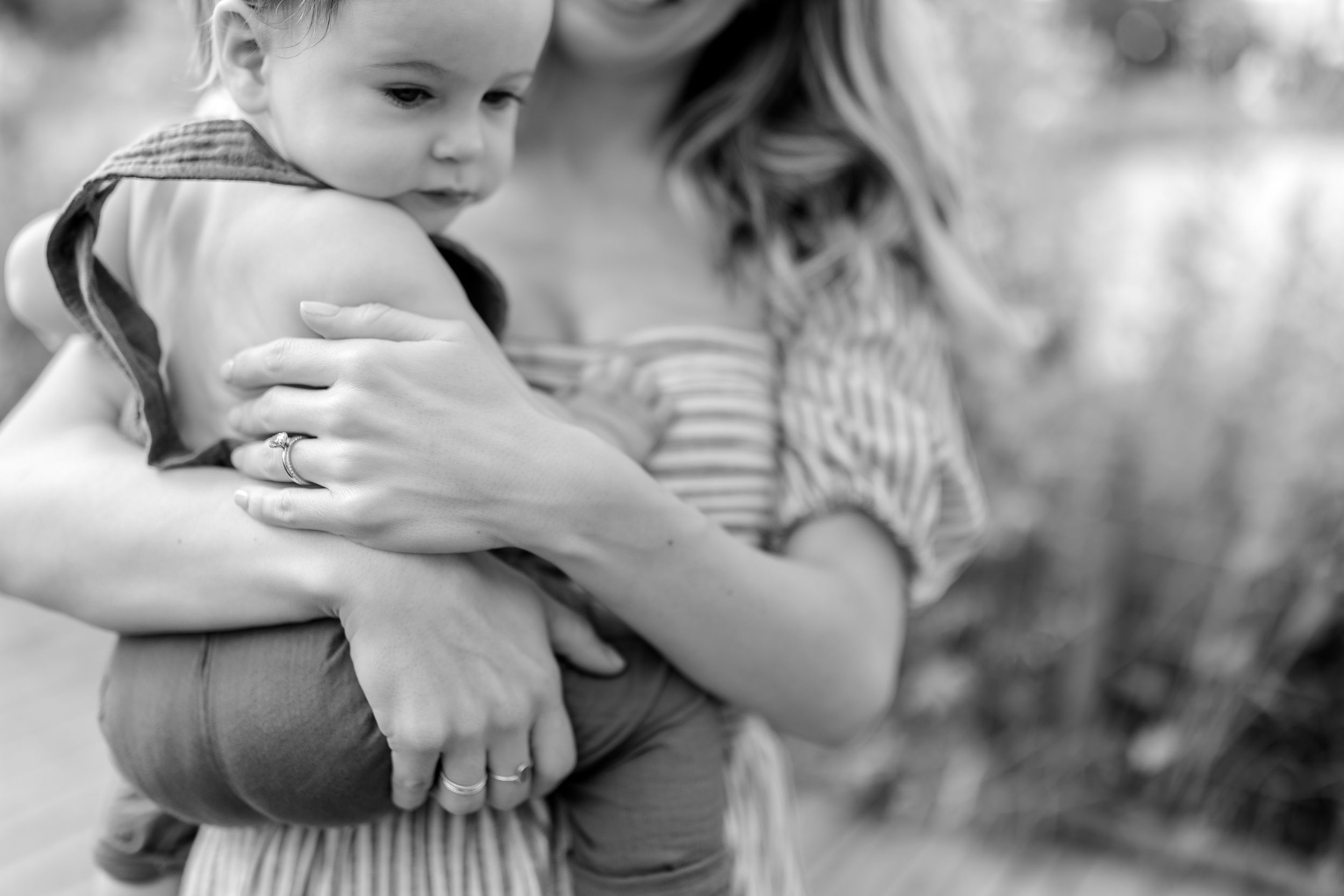 Intimate black and white photograph showing tender family embrace.