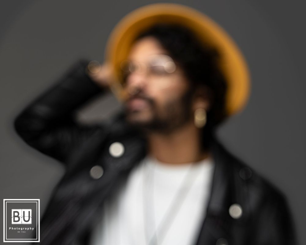 Stylish portrait with brown hat and leather jacket in soft focus.