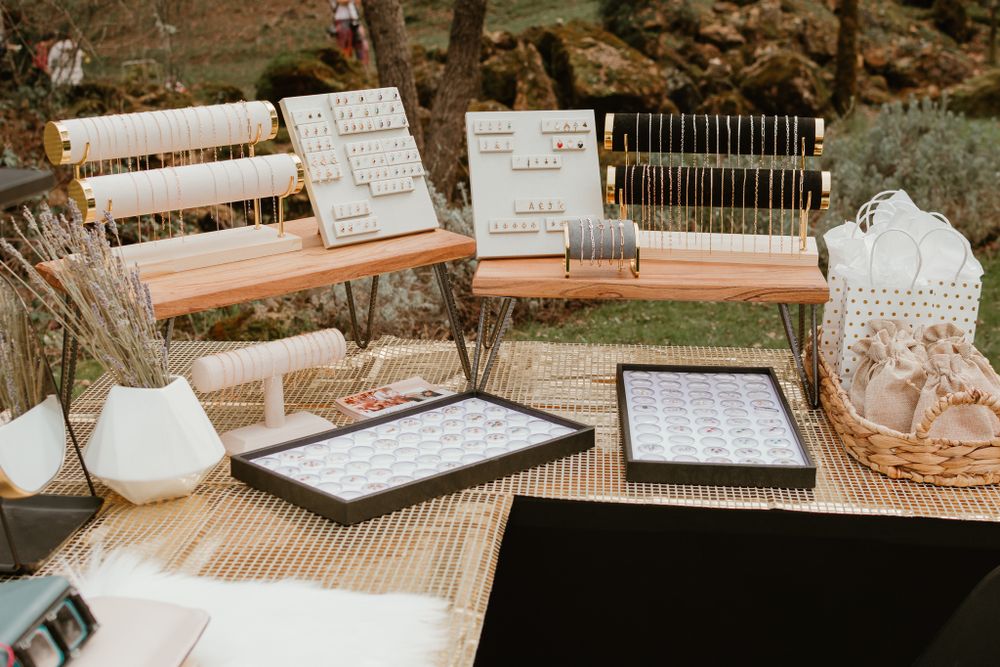 Wedding guest book and seating chart display on rustic wooden tables.
