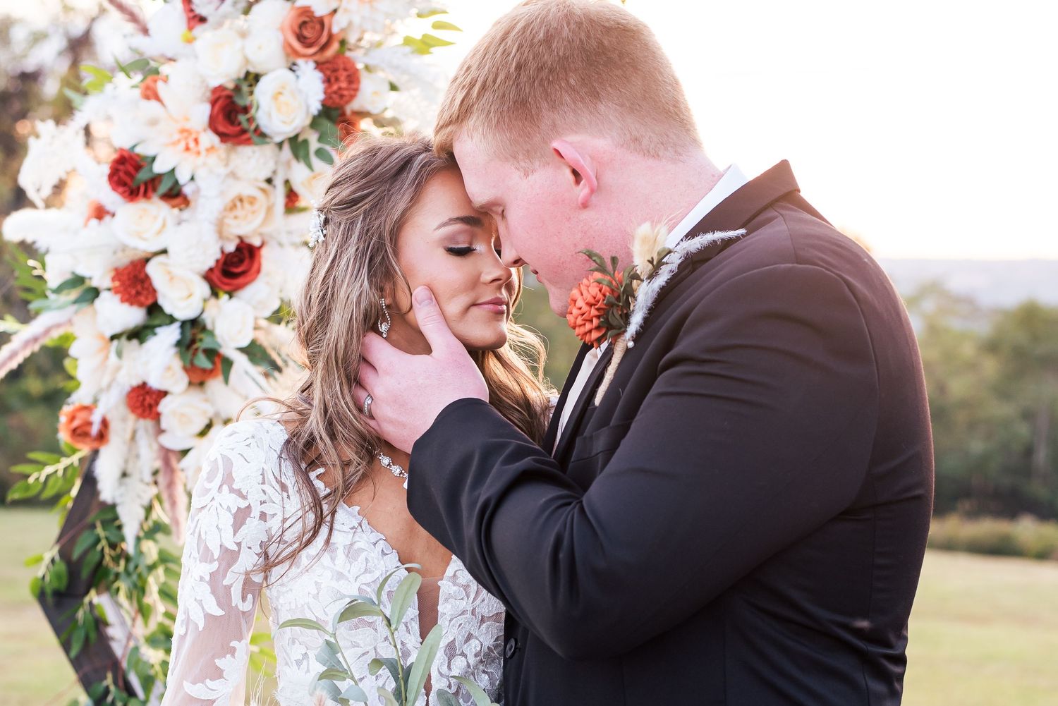 A dreamy sunset portrait of a groom embracing his bride at Burdoc Farms in western Kentucky.