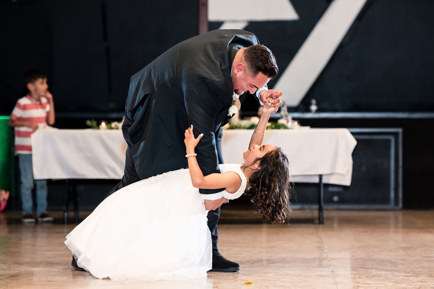 A dramatic dip during a wedding dance on a wooden floor.