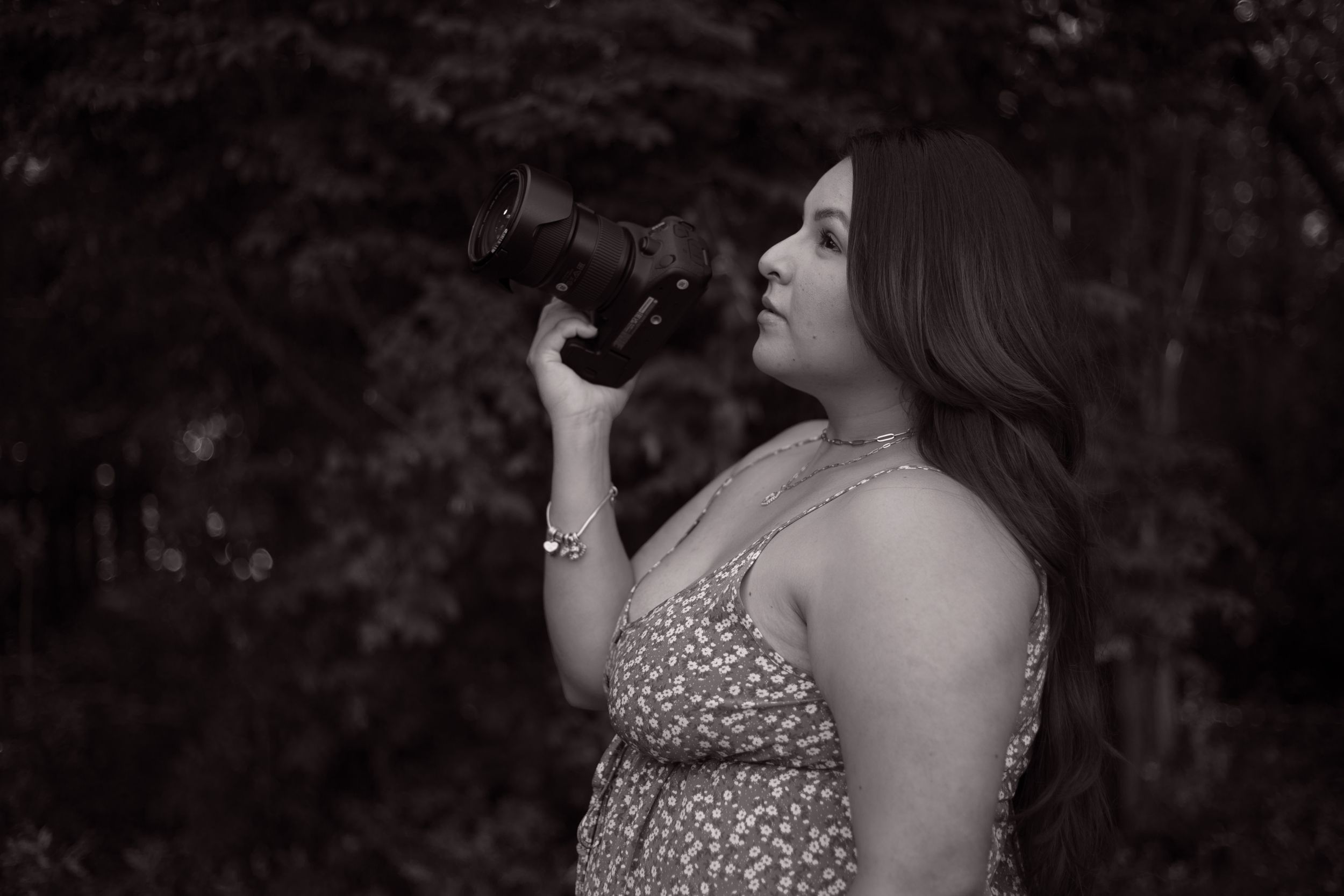 black and white portrait of a photographer holding a camera