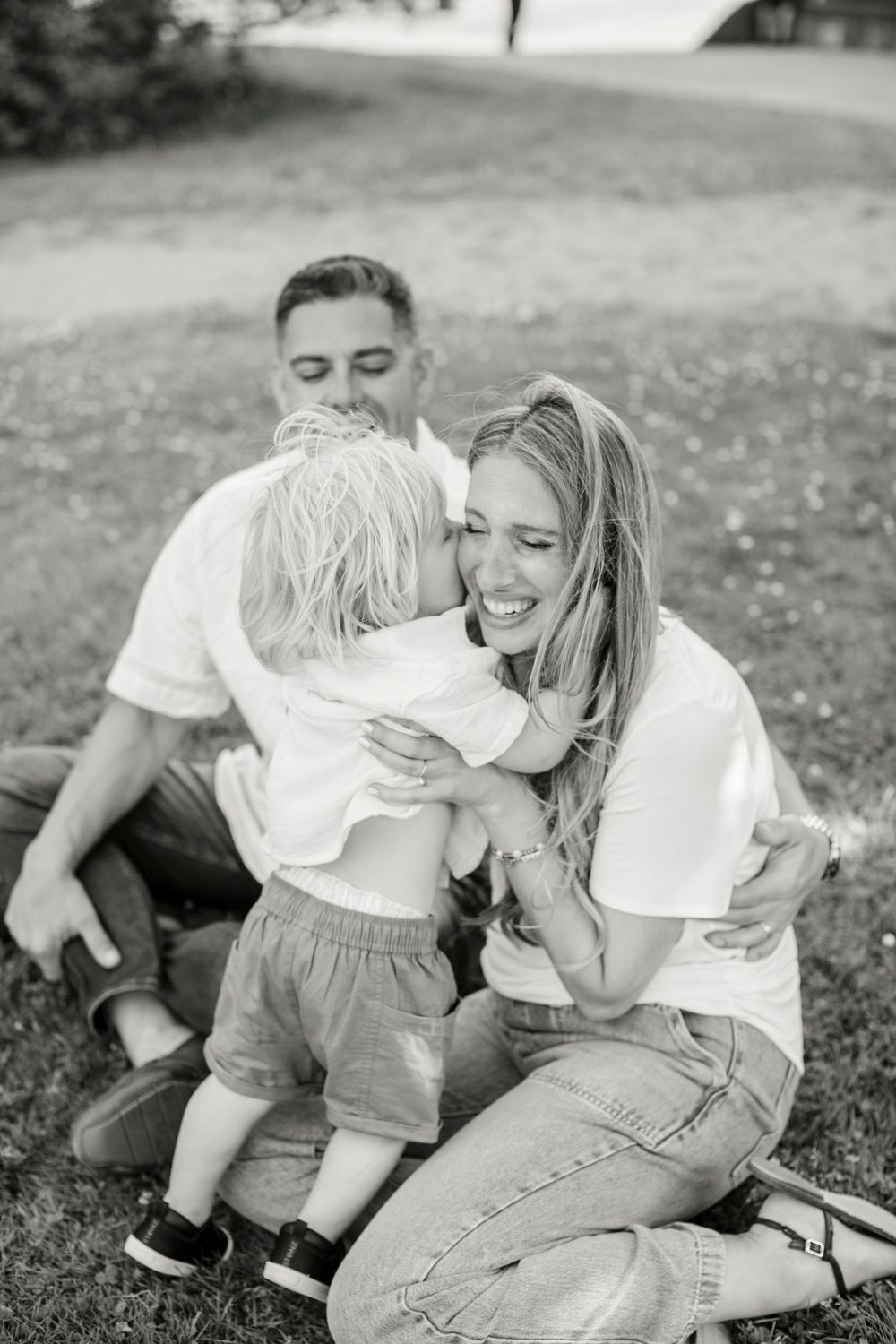 Black and white photo series showing playful moments of parent and child bonding in casual outdoor setting.