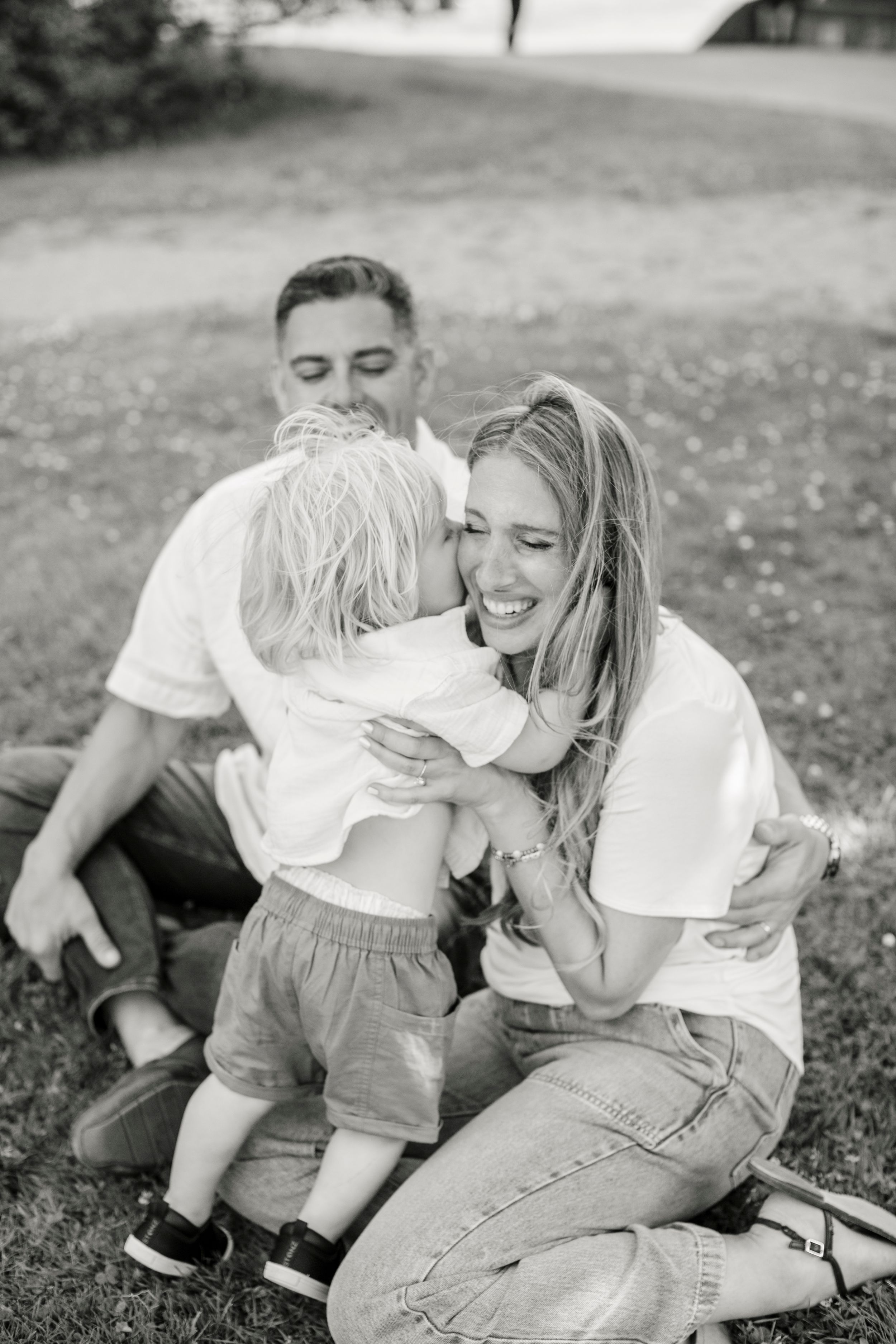 Black and white photo series showing playful moments of parent and child bonding in casual outdoor setting.