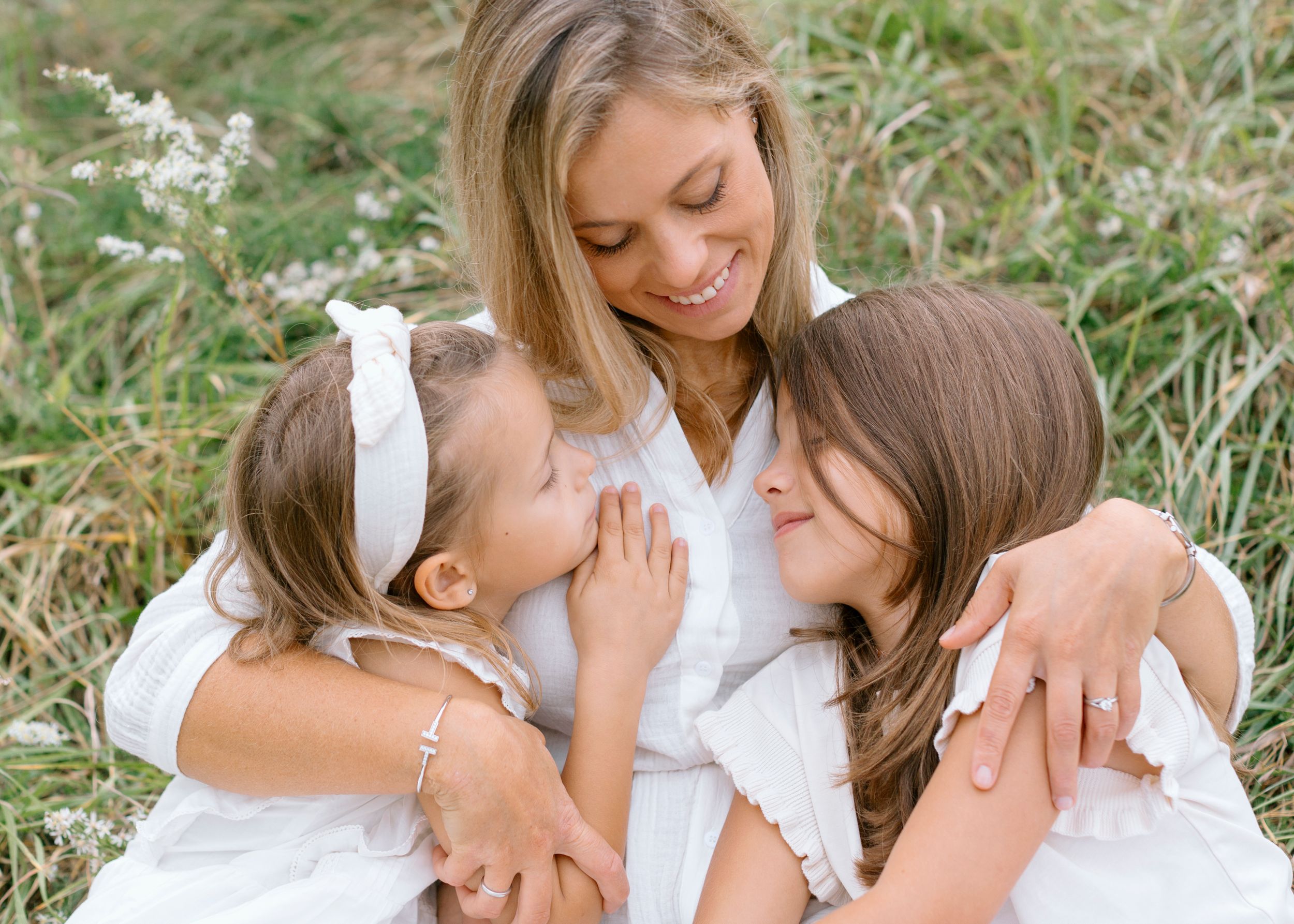 A heartwarming series of family photos with people wearing white outfits sharing joyful moments outdoors in nature.