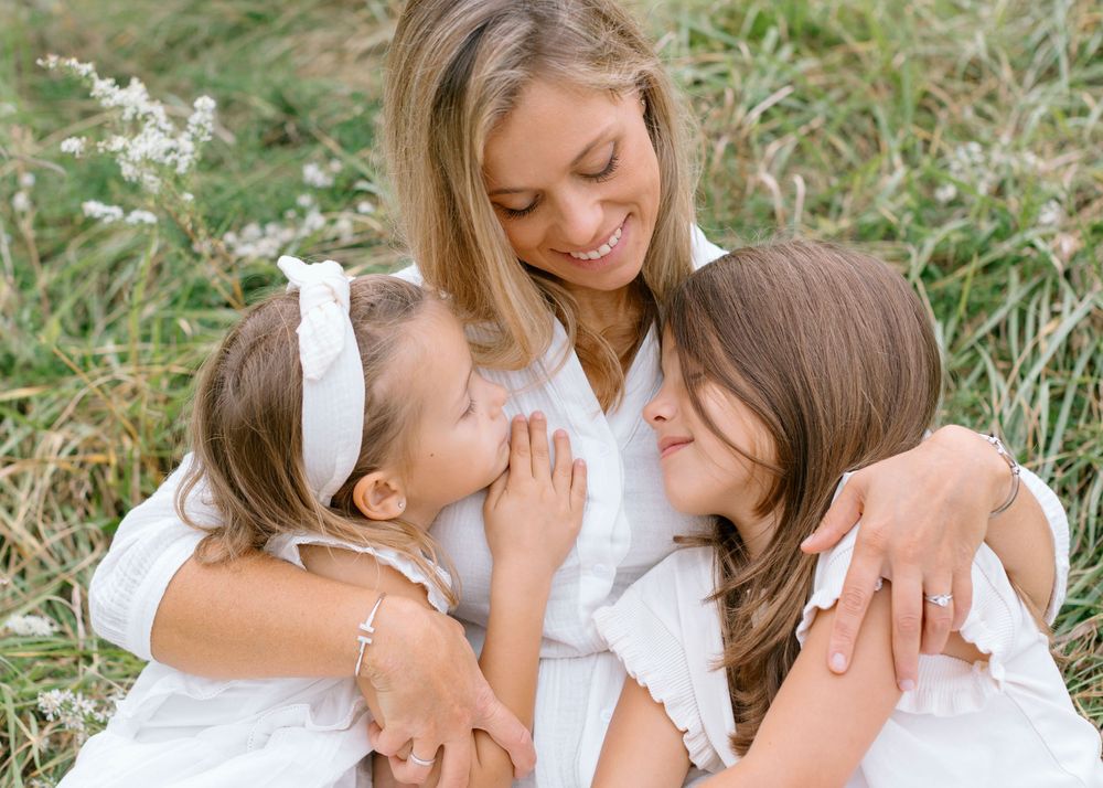 A heartwarming series of family photos with people wearing white outfits sharing joyful moments outdoors in nature.