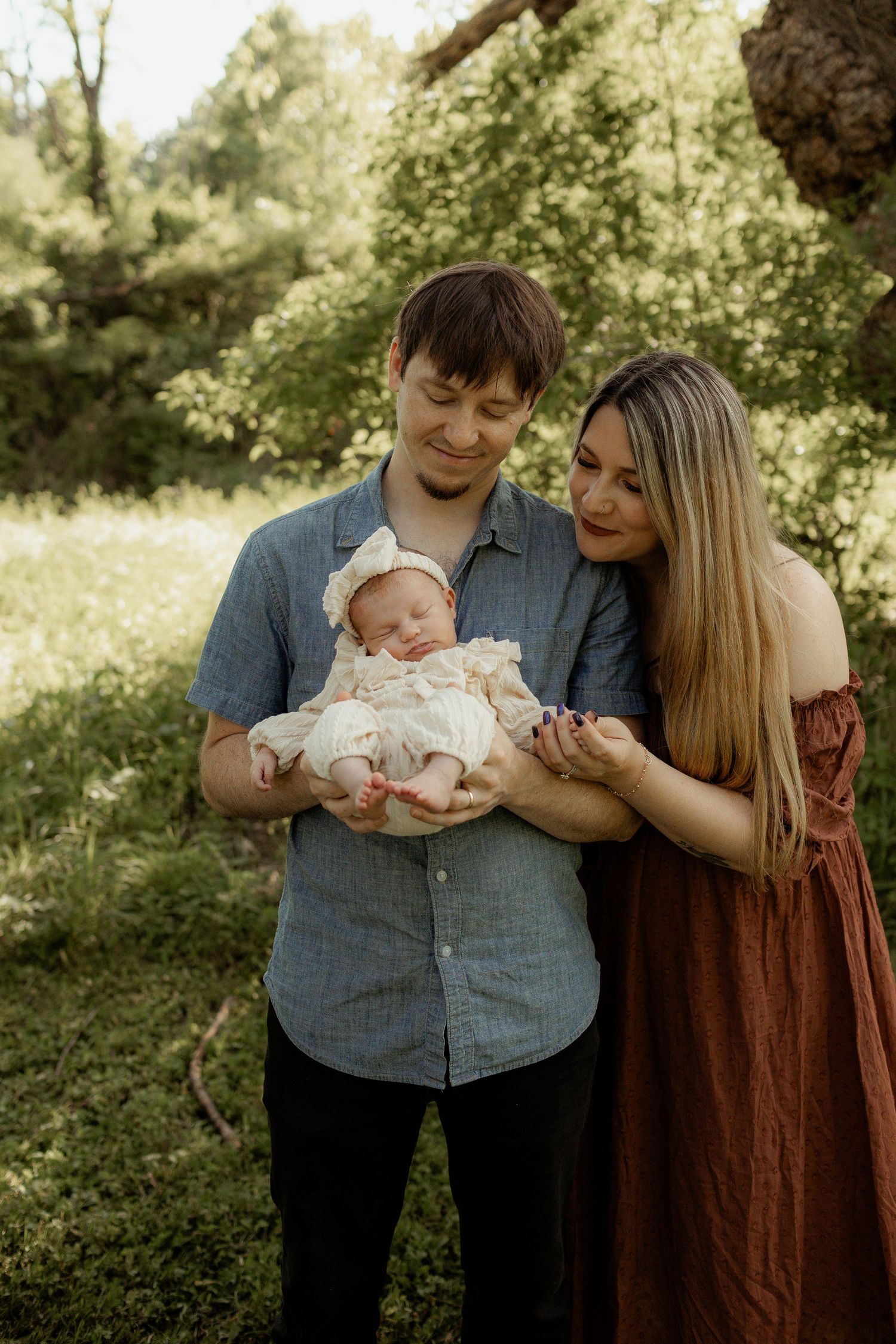 A serene outdoor scene with sunlight filtering through trees onto a grassy area.