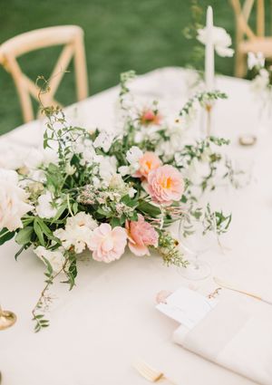 Elegant table setting with blush pink garden roses and delicate greenery garland on white linen tablecloth. MacArthur Place Hotel