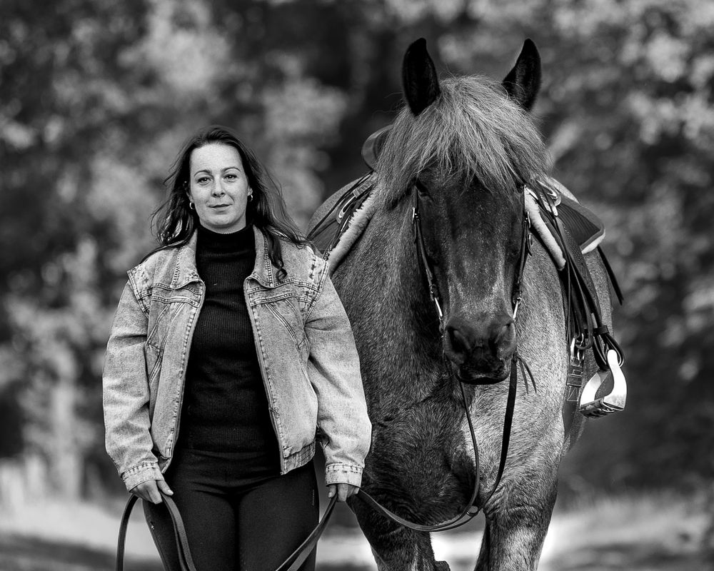 A series of grayscale equestrian portraits showing a person and horse walking and bonding together outdoors.