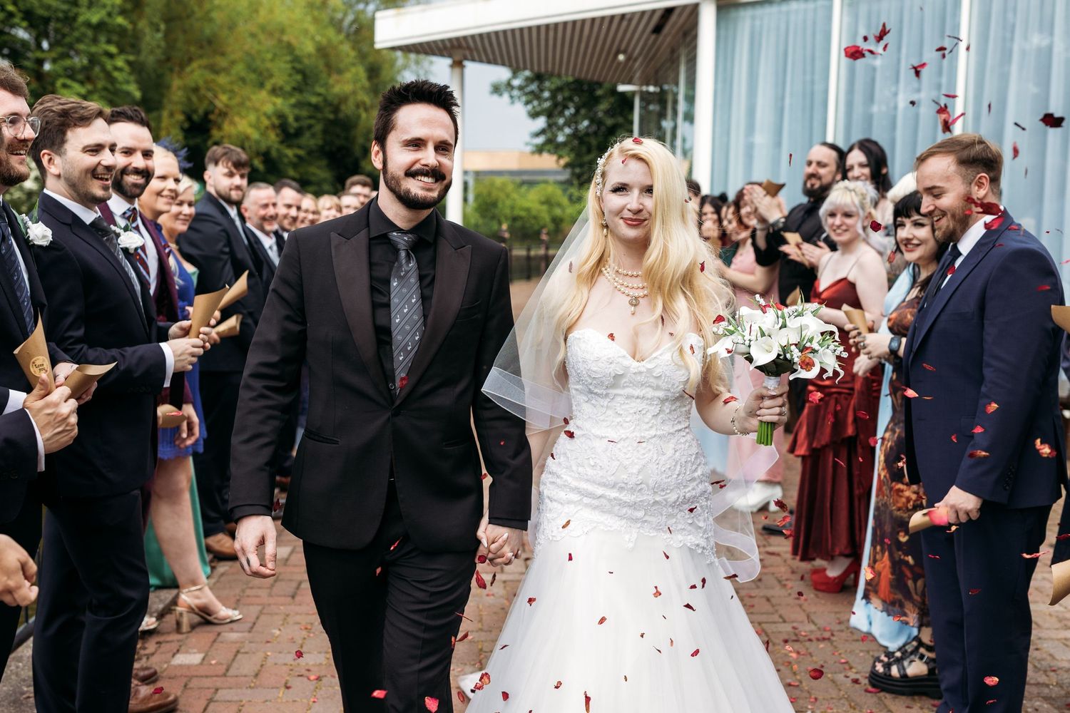 Groom in kilt and bride in white wedding dress. Wedding photography at Monton Sports village, Manchester