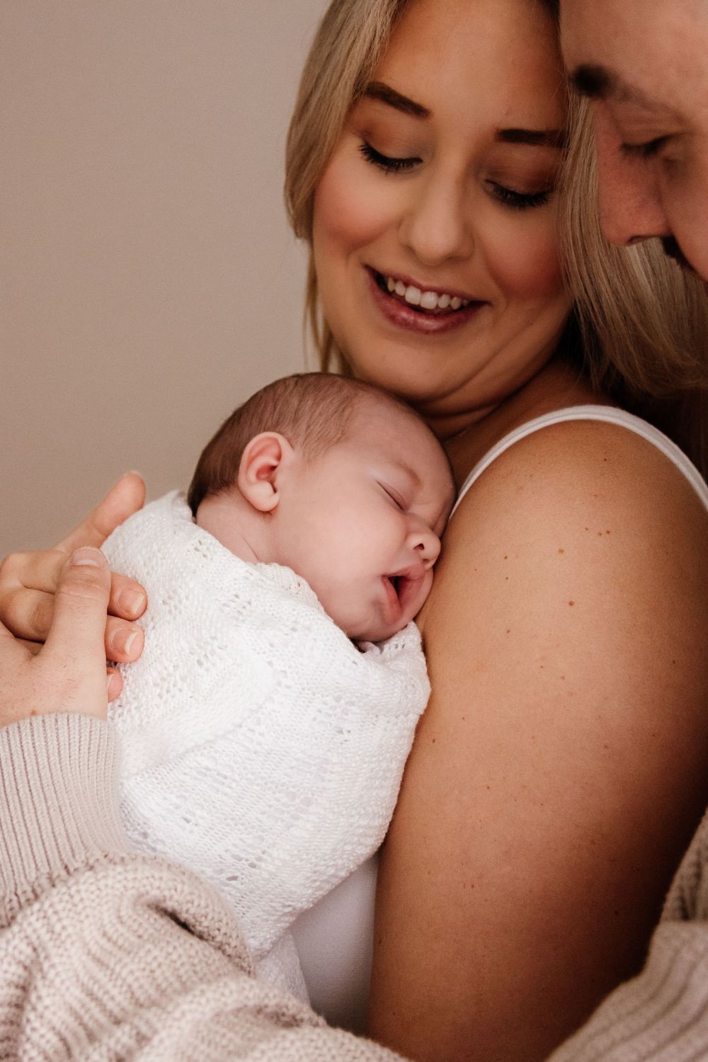 Sweet newborn photography session with baby in white knit wrap. Captured in a natural light studio in the blue mountains Sydney
