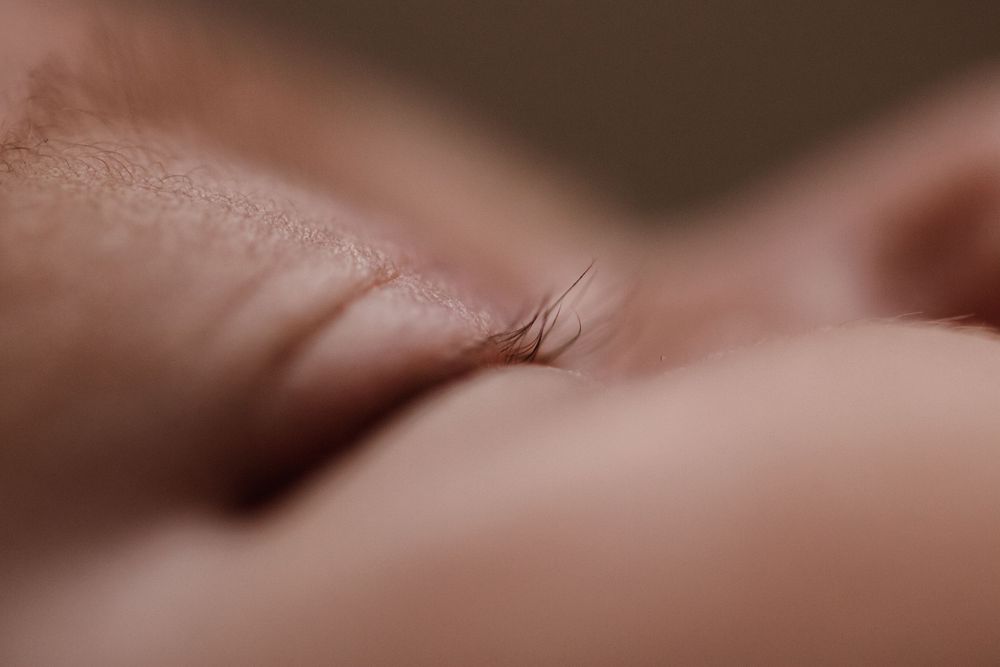 Abstract macro shots showing soft details of newborn features in warm tones. Photographed in a natural light studio in the blue mountains