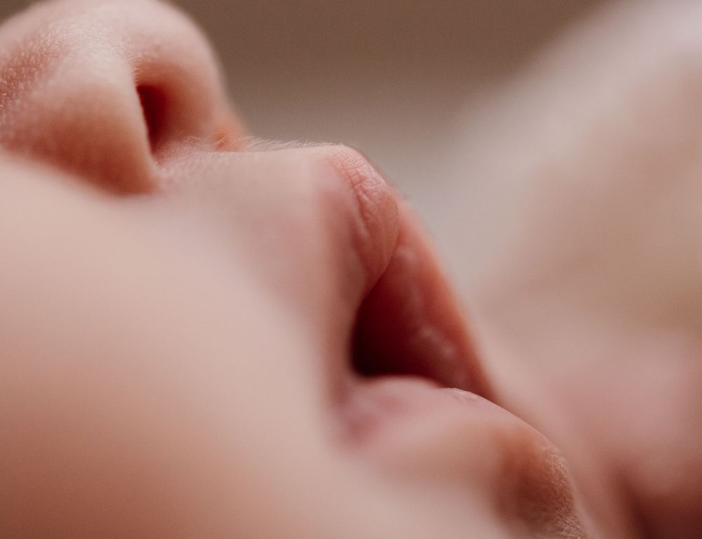 Artistic macro detail of a newborn baby shot in soft muted tones. Photographed in a natural light studio in the blue mountains