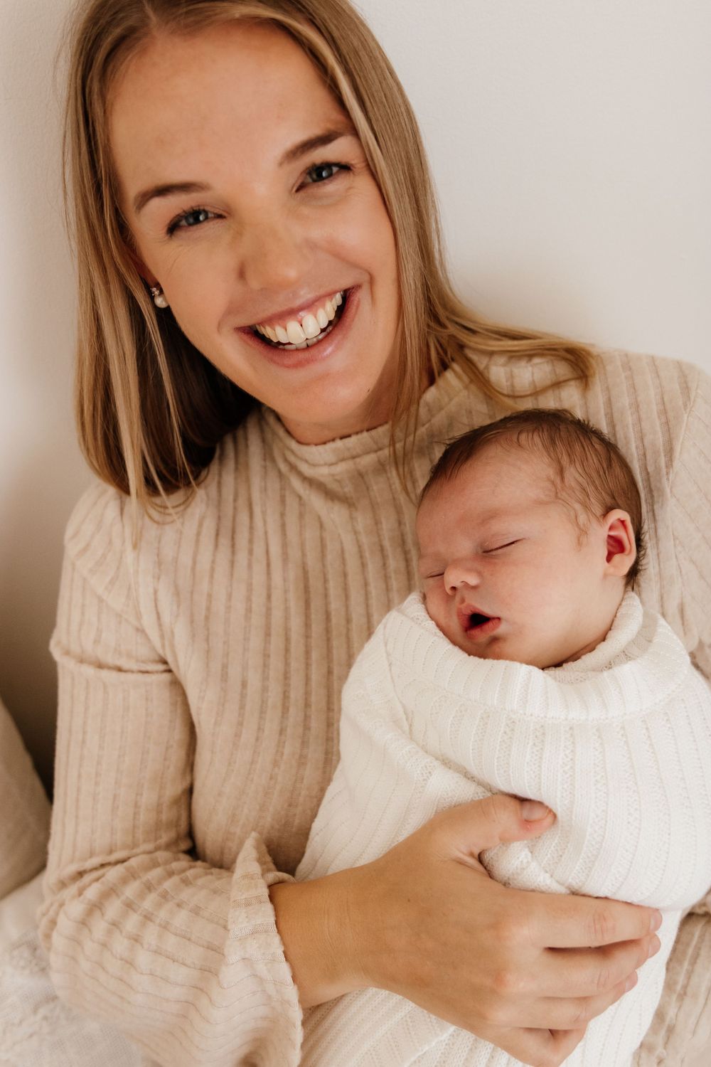 Tender moments captured in a series of photos showing a parent bonding with a newborn baby in soft natural lighting.