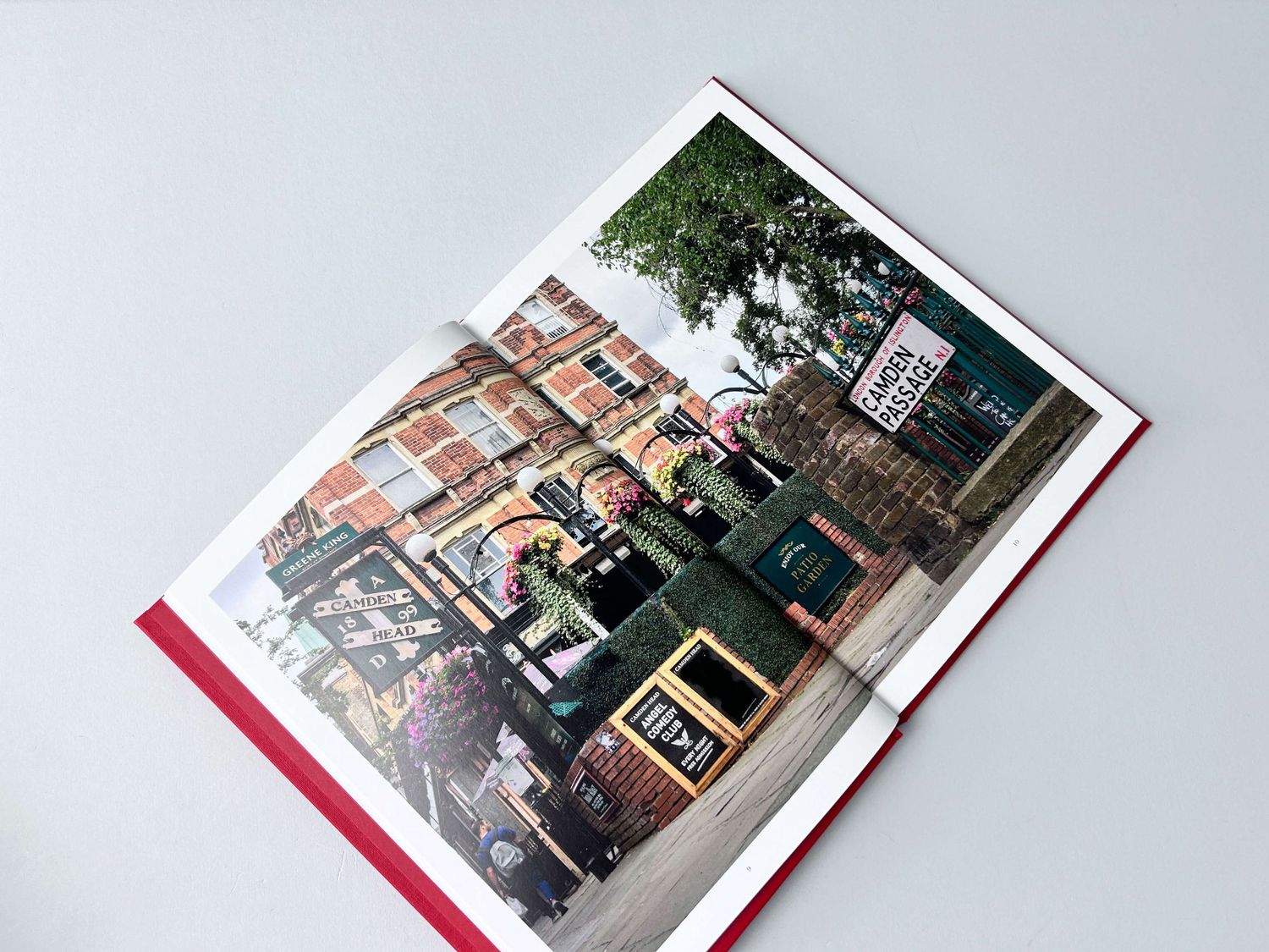 An open book displaying an urban street scene photograph about Camden Passage