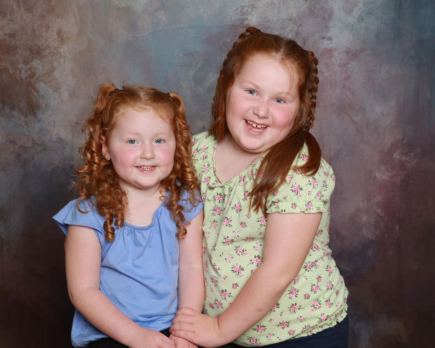Sibling school portrait with matching outfits and clean backdrop