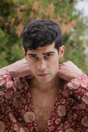Outdoor portrait with subject wearing a red floral pattern robe.
