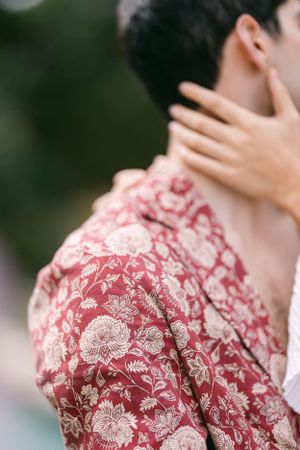 Close-up detail of a red and white floral patterned garment with delicate embroidered details.