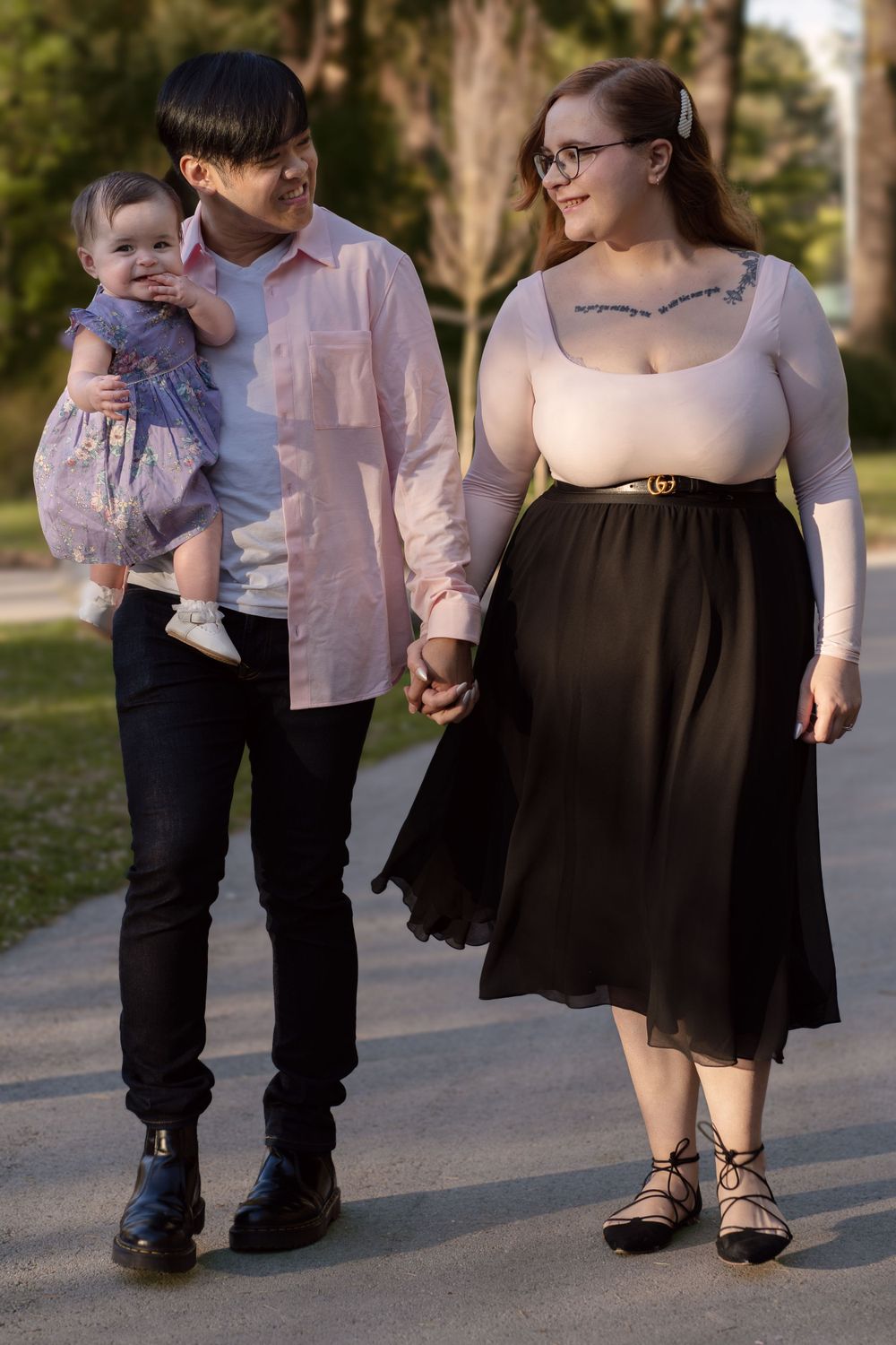 Family members walking together on a path during a sunny autumn day.