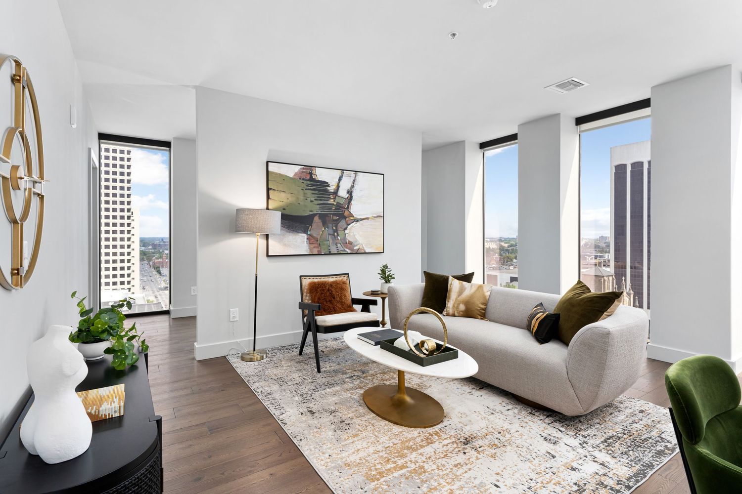 Modern white apartment interior with floor-to-ceiling windows, and contemporary furnishings.