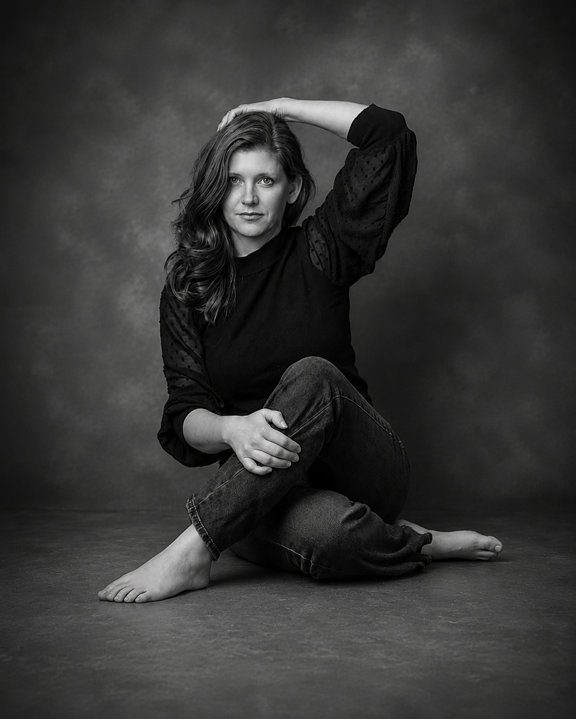 Black-and-white studio portrait of a seated woman against a dark, textured backdrop by Chris Cleveland Photography in Fulton, Missouri.