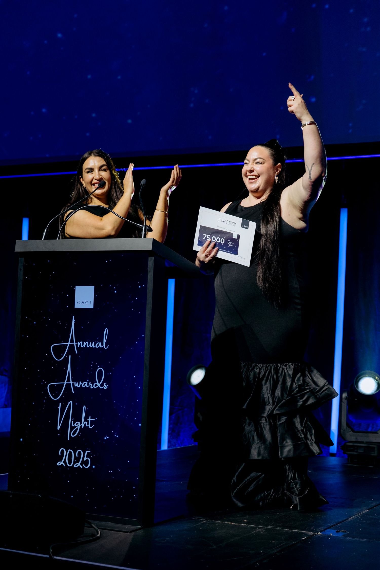 Contemporary event photography capturing vibrant stage decorations and joyful moments of award presenters