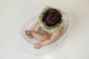 baby in milk bath tub during cake smash session