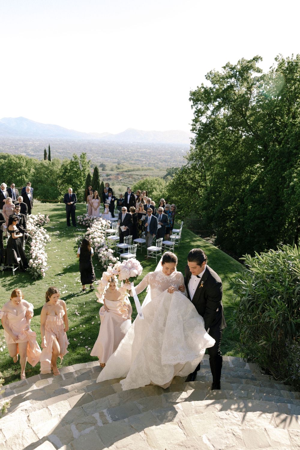 Bride and groom surrounded by their guests during a destination wedding ceremony in Tuscany, Italy set against the Tuscan coutryside