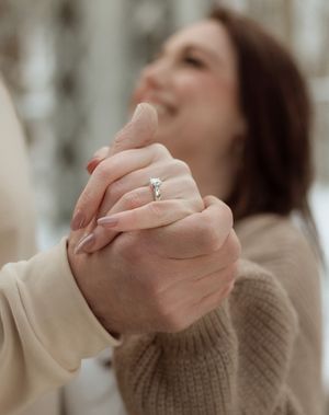 A series of close-up shots showing hands wearing an engagement ring in soft, natural lighting.