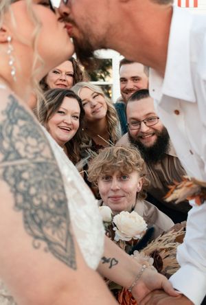 Close-up candid shots of wedding guests joyfully smiling and laughing together at a celebration.