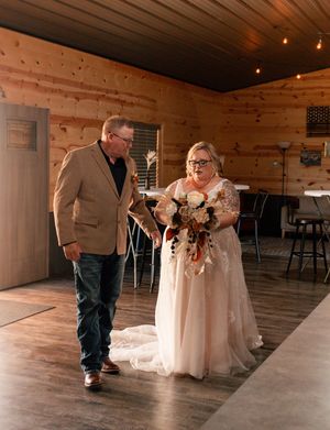 A heartwarming sequence shows a father and daughter dancing together at what appears to be a rustic wedding venue.