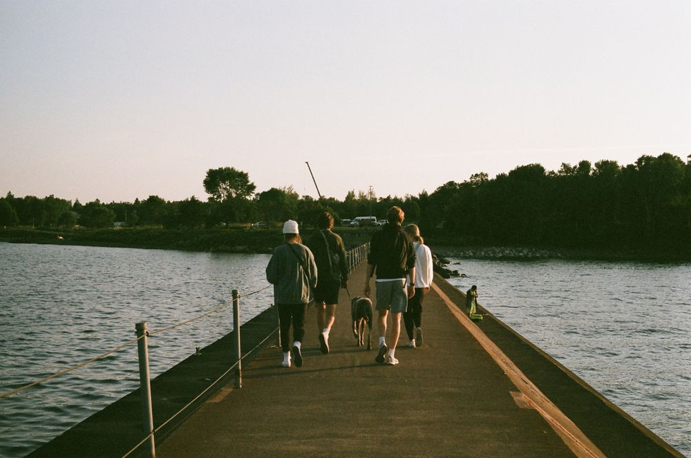 Friends walking down the dock in Two Harbours Minnesota on film