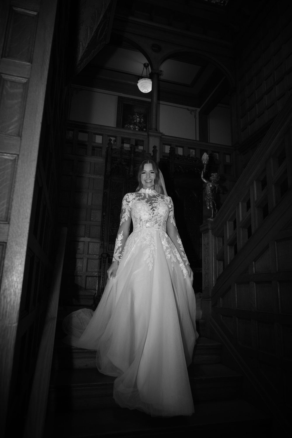 Beautiful bride walking down the stairs in black and white