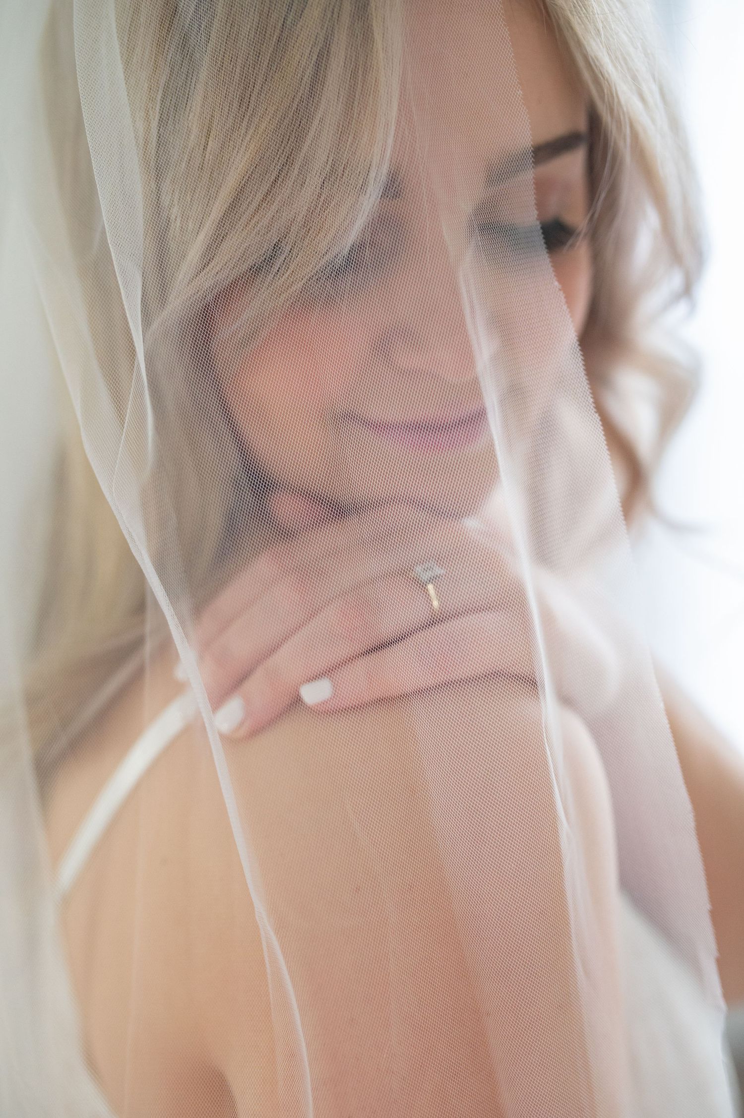 Ethereal collection of blurred images with soft white veil fabric in gentle light.