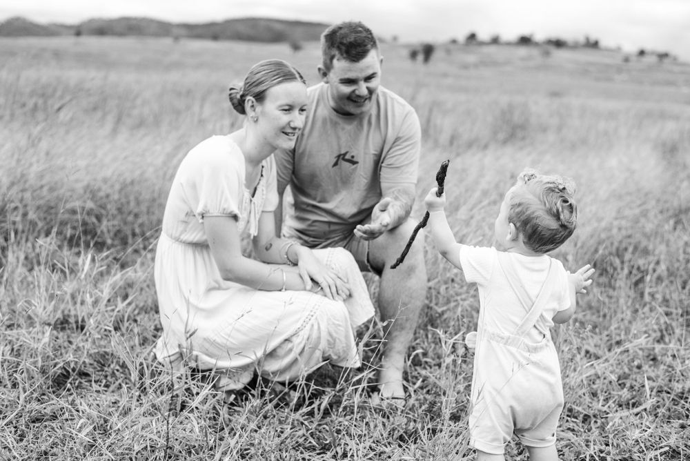 Family lifestyle moments captured in a black and white photo series outdoors.