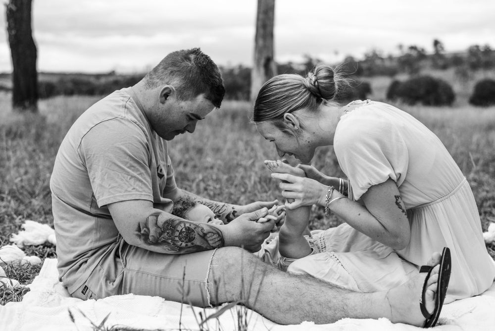 A collection of intimate black and white family moments in a natural setting.